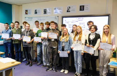 Maths students with certificates at the front of class