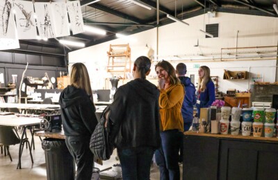 lecturer talking to prospective students in the art barn.