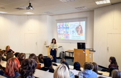 Author talking to seated students.