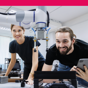 Two students working with machinery