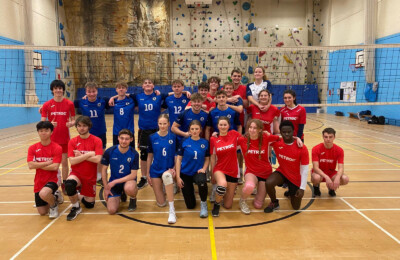 volleyball teams posing after game.