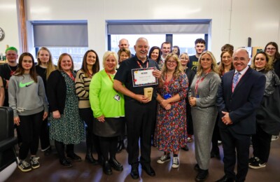 staff and students presenting the teach of the year awards to barbering lecturer, Derek Jenkins.
