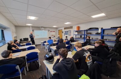 students in classroom talking about ADAS systems with teacher.