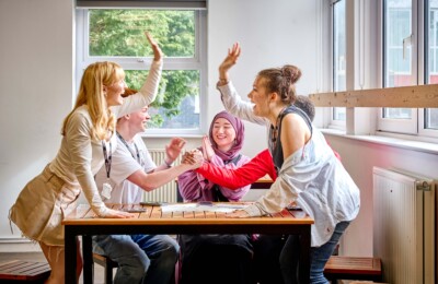 students laughing and high fiving