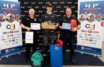 Zeb and his tutor posing with competition prizes.