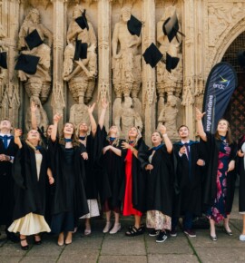 Graduates celebrating outside Exeter Cathedral
